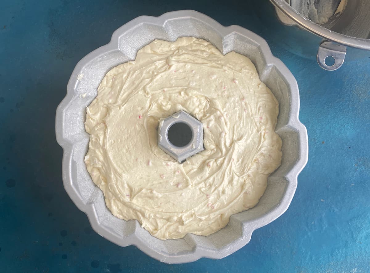 Cake batter in prepared bundt pan.