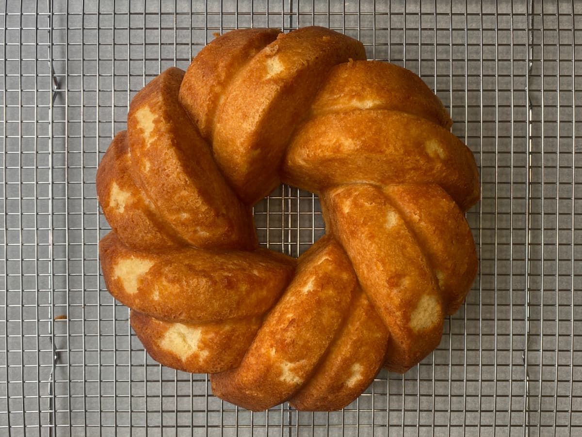 Overhead of baked bundt cake on wire cooling rack.