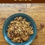 A bowl of pecan granola in a small bowl. Pin text reads: Easy Maple Nut Granola