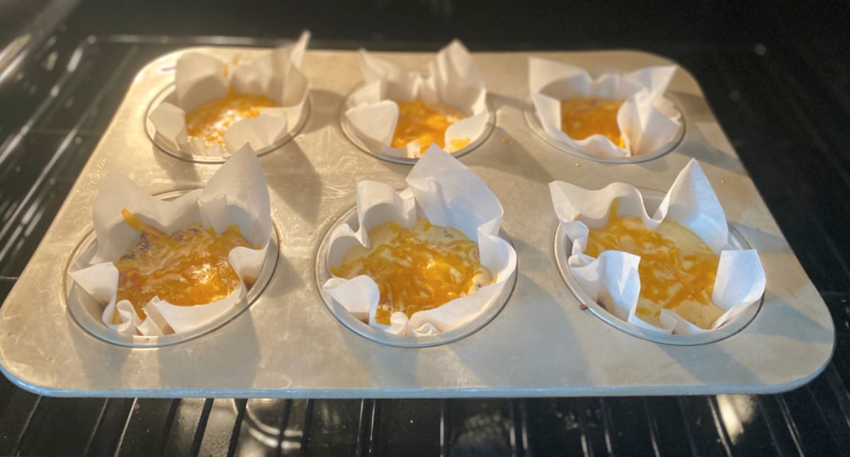 Casserole muffins baking in oven.