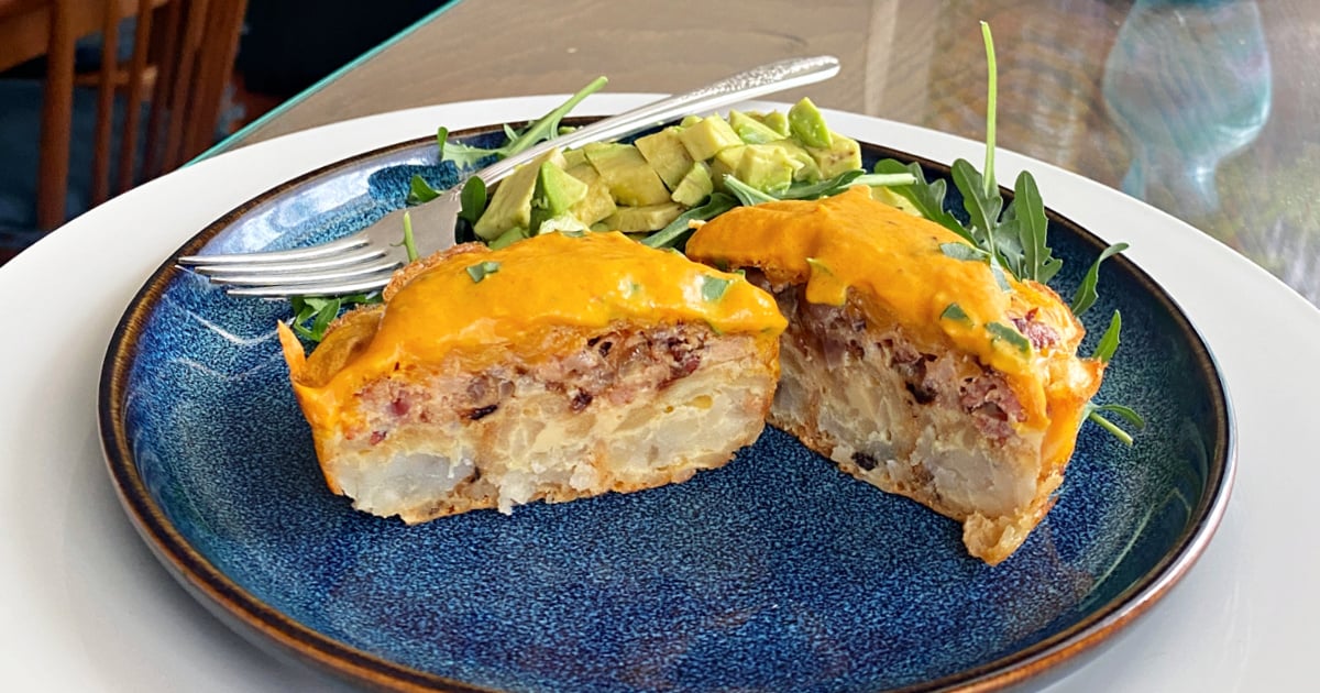 Breakfast muffins cut in half and opened to show the center layers.