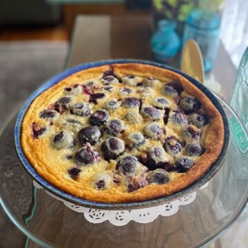 Cherry clafoutis baked in a pie dish, ready to serve.