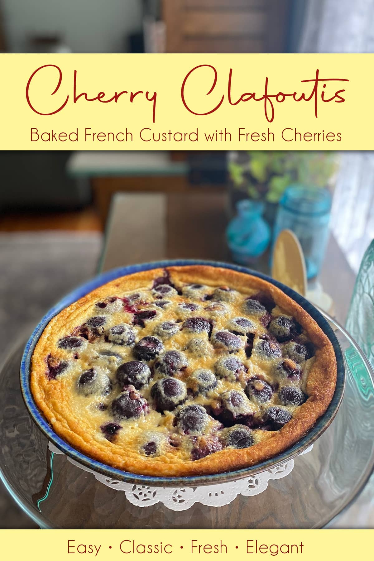 Cherry clafoutis baked in a pie dish, ready to serve. Pin text reads, "Cherry Clafoutis, Baked French Custard with Fresh Cherries | Easy, Classic, Fresh, Elegant."