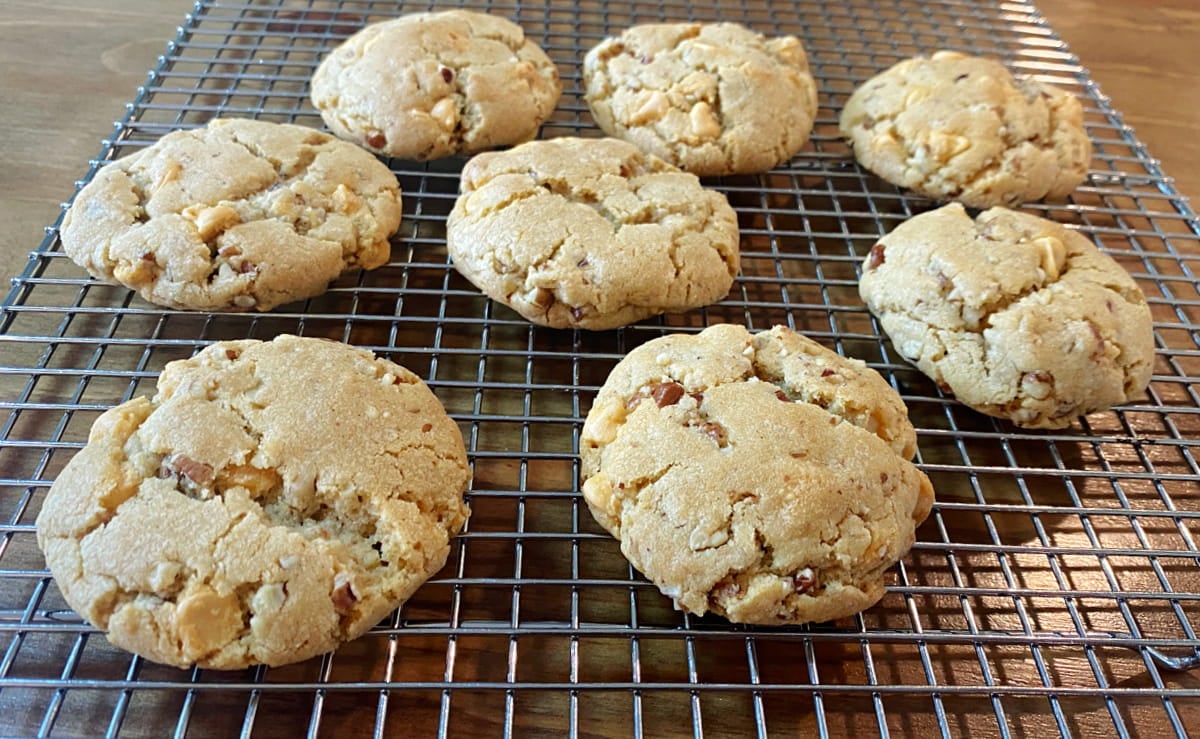 Freshly baked butterscotch pecan cookies cooling on a cooling rack.