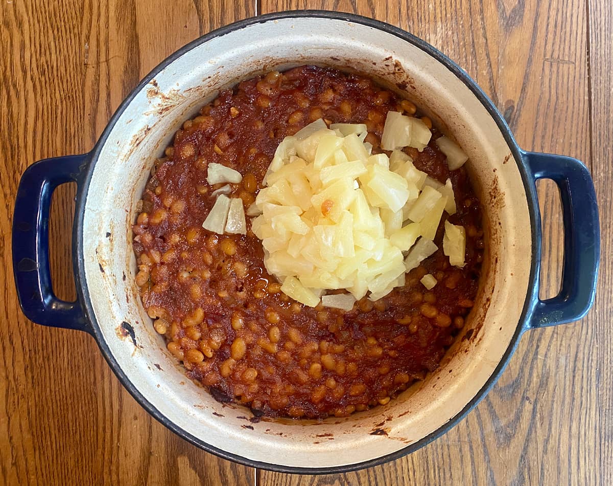 Adding pineapple tidbits to the beans at the 2-hour mark.