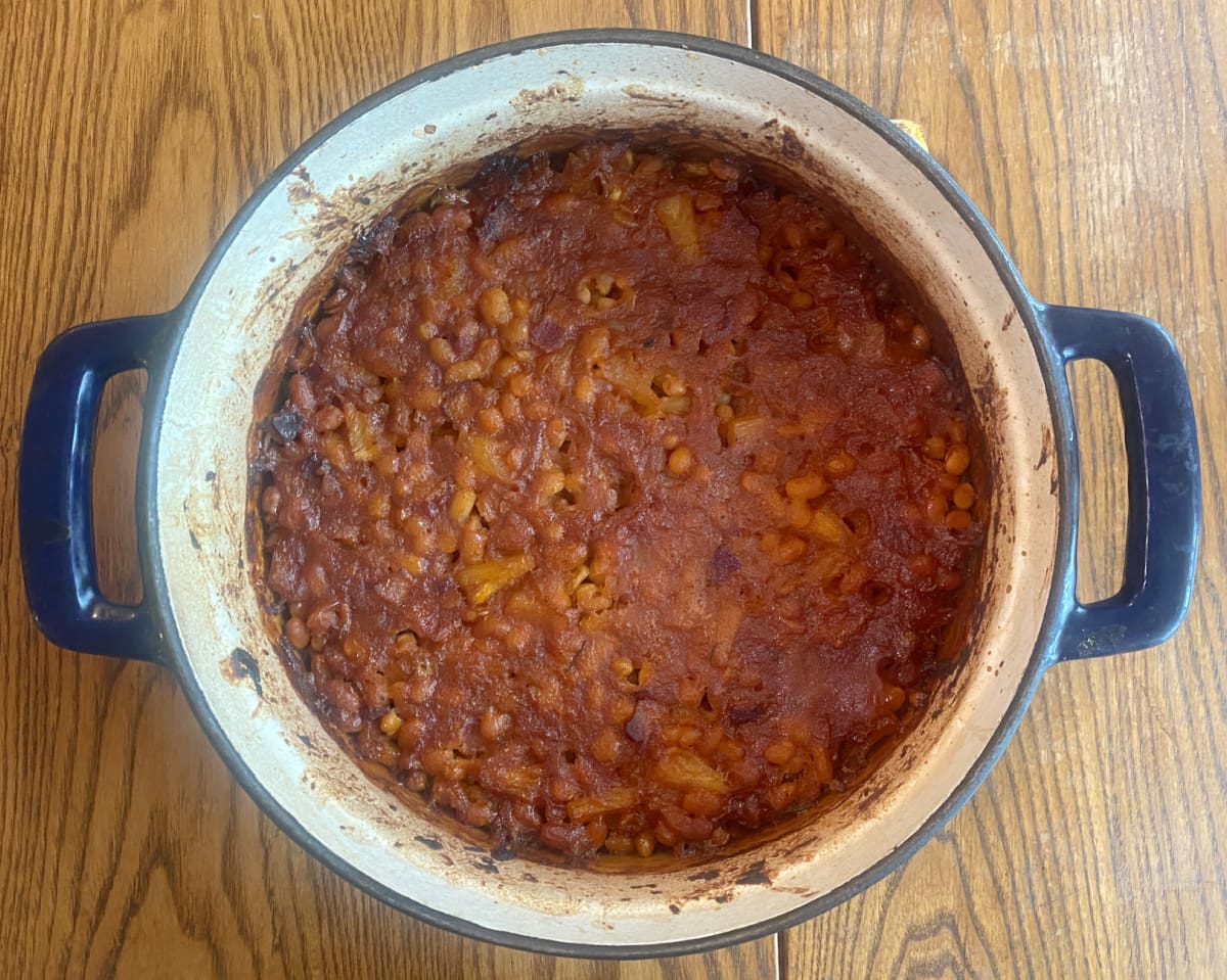 Pineapple baked beans slowly cooking until thick, rich, and caramelized.
